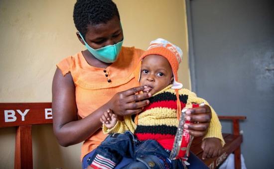 Jane Wanjiru gives her baby son Mark Moses (11 months old) therapeutic food she received as part of his nutritional treatment at Mukuru Health Centre. Photo: Ed Ram / Concern Worldwide